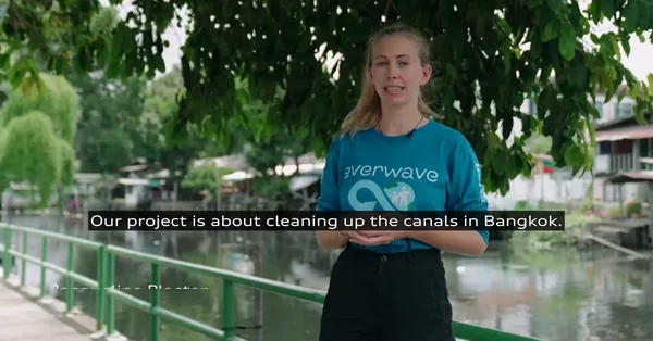 A frame from the documentary: an Everwave team member beside a canal in Bangkok