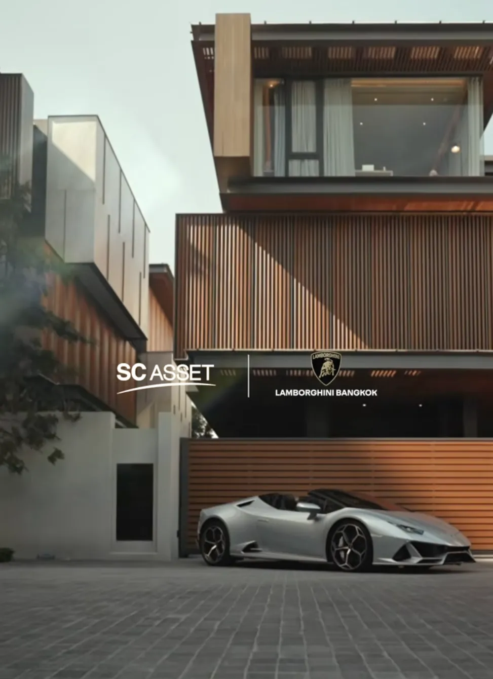 Sonle Residences by SC Asset with Lamborghini Bangkok: a silver Lamborghini in front of a timber-clad house
