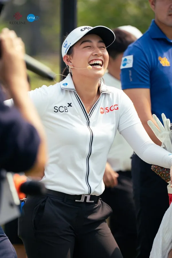 A golfer laughing among guests